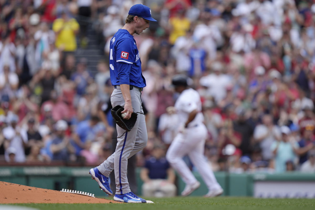 Kansas City Royals' Brady Singer, left, walks across the mound as Boston Red Sox's Rafael Devers runs the bases after hitting a two-run home run in the first inning of a baseball game, Sunday, July 14, 2024, in Boston. 