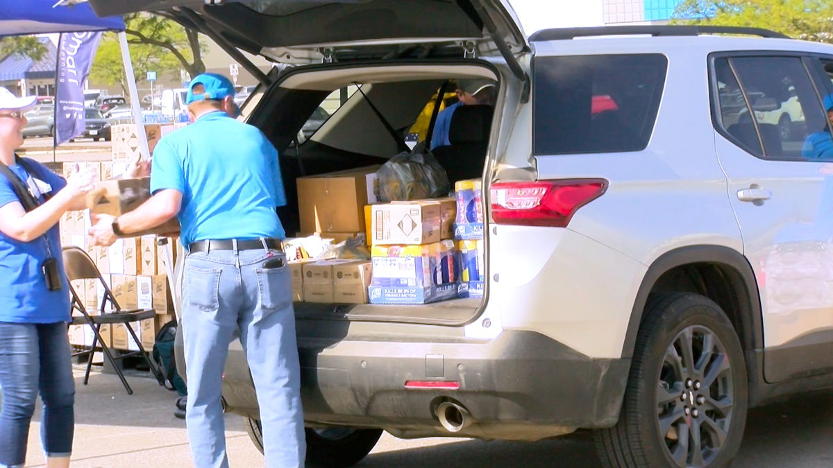 Volunteers help load schools supplies into teachers' vehicles on Tuesday, July 30, 2024.