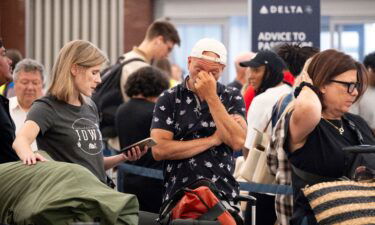 Passengers try to rebook their flight to Iowa at Hartsfield Jackson International Airport in Atlanta on Friday amid the major tech outage.