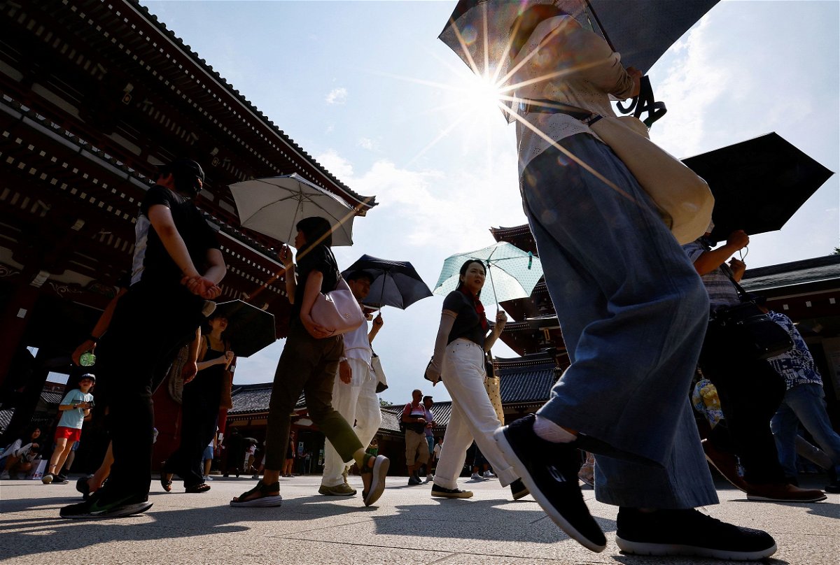 July 21 was the hottest day in recorded history, according to European Union’s Copernicus Climate Change Service, and people are seen shading themselves from the sun during extreme heat in Tokyo on July 22.
