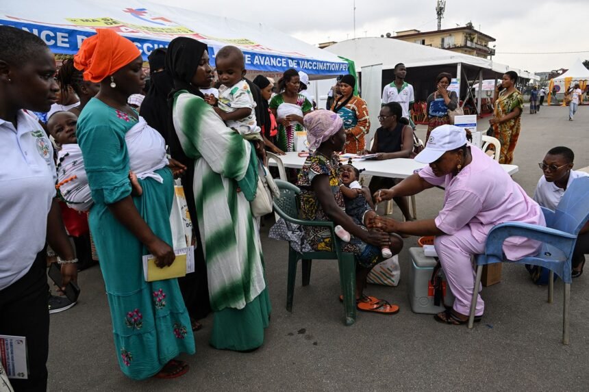 A health employee prepares to give a malaria injection to a child during the official ceremony for the launch of a malaria vaccination campaign in Ivory Coast.