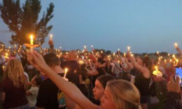 People hold candles at the vigil held for Gavin Peterson