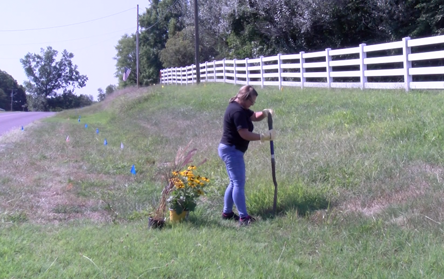 A woman demonstrates safe digging with Missouri 811 on Monday, Aug. 5, 2024.