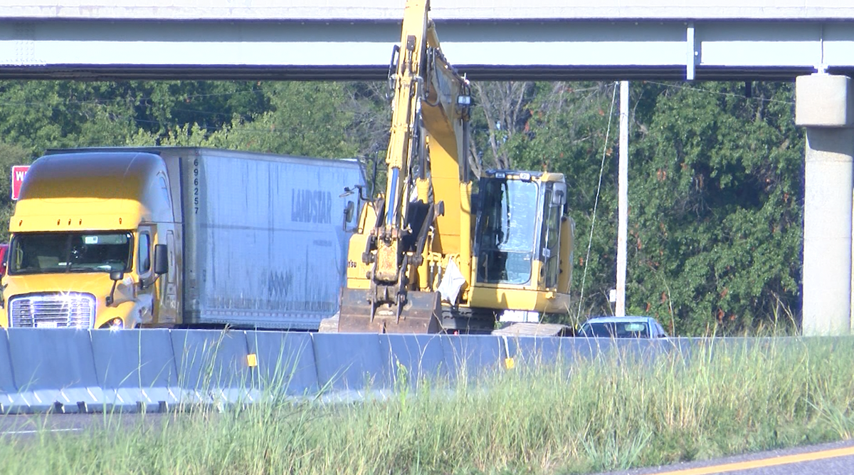 A tractor-trailer is seen driving past a construction zone on Interstate 70 on Wednesday, Aug. 7, 2024. Three people have died in the past two days from crashes on the interstate that have involved a semi.