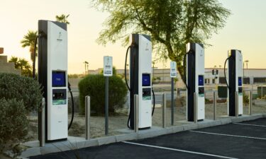 A line of EVs wait to charge at Electrify America chargers in East Brunswick