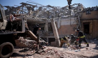 A man walks among debris inside the hotel targeted by a Russian missile.