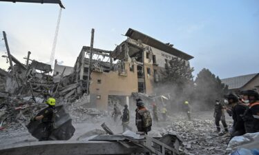 Rescuers work at a site of a Russian missile strike