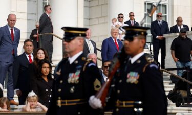 Former President Donald Trump observes a changing of the guard at the Tomb of the Unknown Soldier alongside Arlington National Cemetery Deputy Chief of Staff Bob Quackenbush at the Arlington National Cemetery on August 26