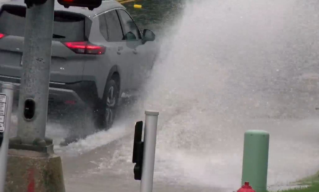 A vehicle drives through water ponding on Providence Road in Columbia on Wednesday, Aug. 14, 2024.