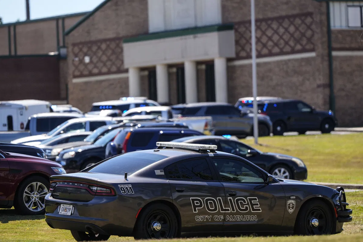 Police vehicles are seen outside Apalachee High School after a shooting there caused an unknown number of injuries and a suspect was arrested Wednesday, Sept. 4, 2024, in Winder, Ga.