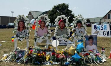 Images of the shooting victims are displayed at a memorial outside Apalachee High School on September 10 in Winder