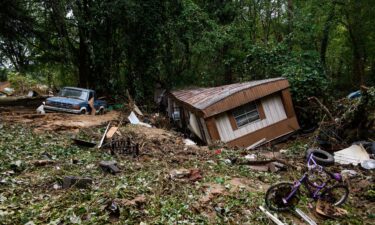 Debris and a mobile home are piled up along a tree line in the aftermath of Hurricane Helene on September 29 in Old Fort