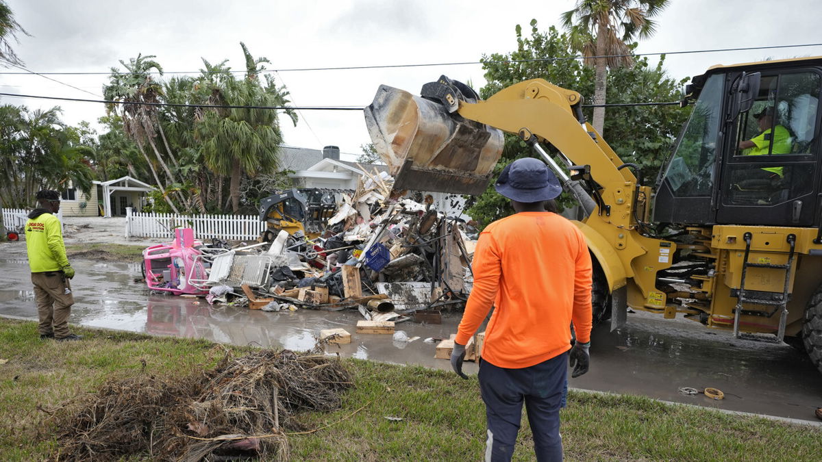 Salvage works remove debris from Hurricane Helene flooding along the Gulf of Mexico Monday, Oct. 7, 2024, in Clearwater Beach, Fla. Crews are working to remove the debris before Hurricane Milton approaches Florida's west coast. 