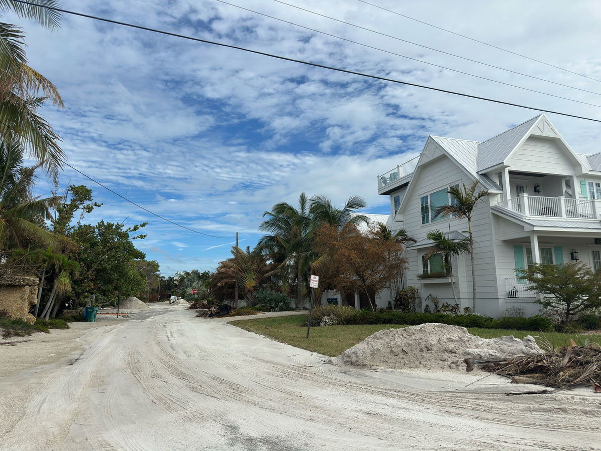 Dune sand pushed inland by Hurricane Helene sits Tuesday on streets on Anna Maria Island in Manatee County, Florida.
