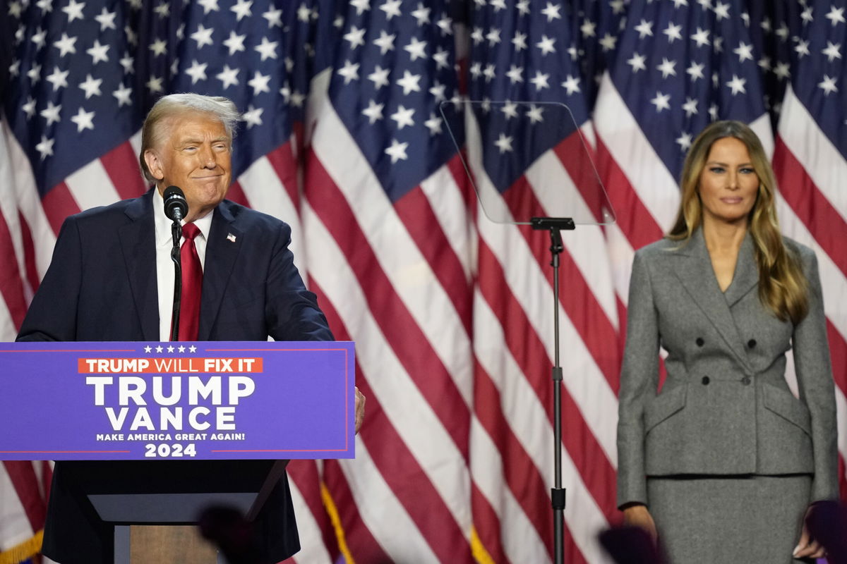 Republican presidential nominee former President Donald Trump speaks as Melania Trump looks on at an election night watch party, Wednesday, Nov. 6, 2024, in West Palm Beach, Fla.