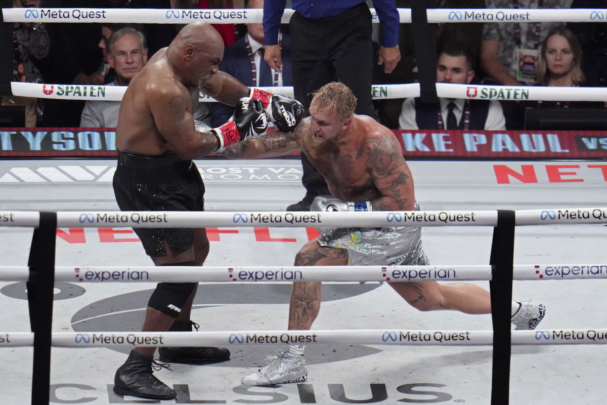 Jake Paul hits Mike Tyson during their heavyweight boxing match, Friday, Nov. 15, 2024, in Arlington, Texas. 