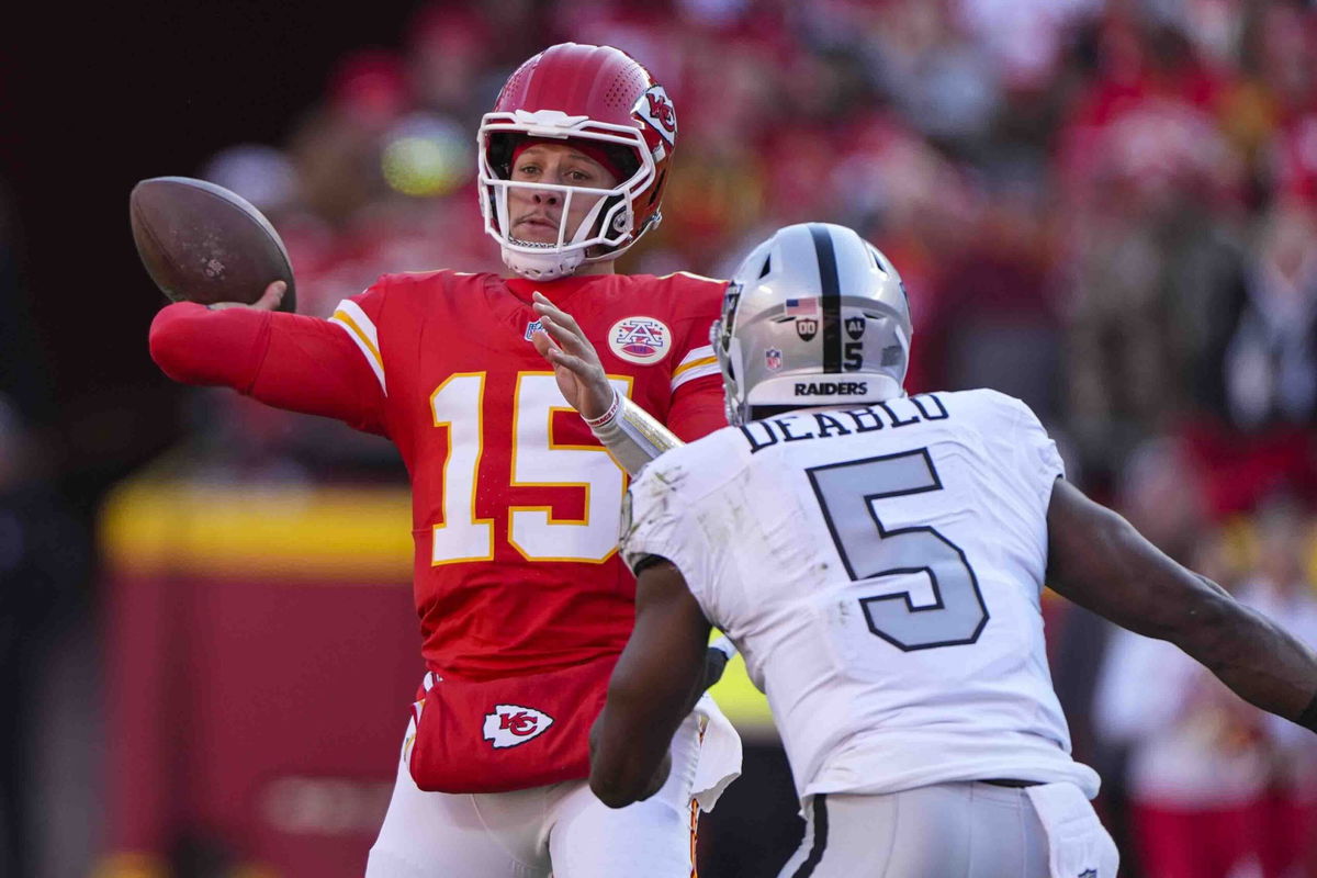 Kansas City Chiefs quarterback Patrick Mahomes (15) throws over Las Vegas Raiders linebacker Divine Deablo (5) during the first half of an NFL football game in Kansas City, Mo., Friday, Nov. 29, 2024. 