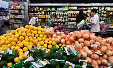 People shop at a grocery store on August 14