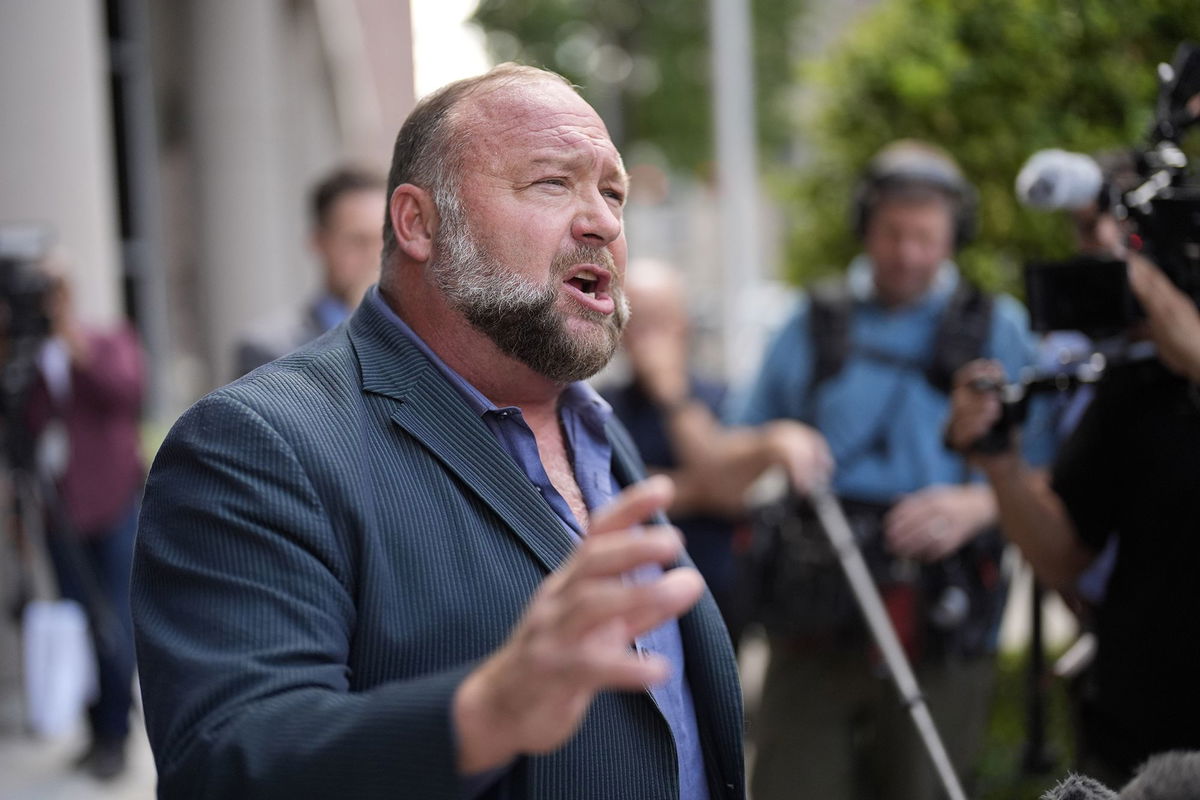 Alex Jones speaks to the media after arriving at the federal courthouse for a hearing in front of a bankruptcy judge, June 14, in Houston.
