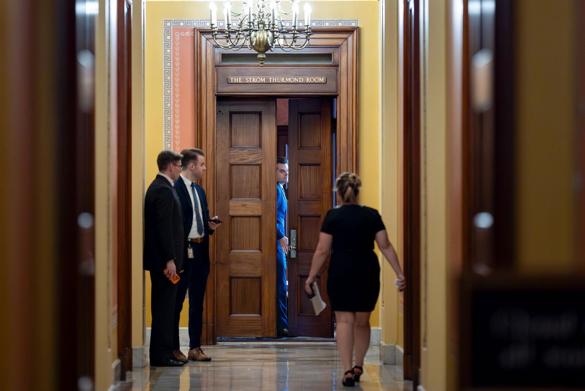 Former Rep. Matt Gaetz, closes a door to a private meeting with Vice President-elect JD Vance and Republican Senate Judiciary Committee members at the Capitol in Washington, DC on November 20.
