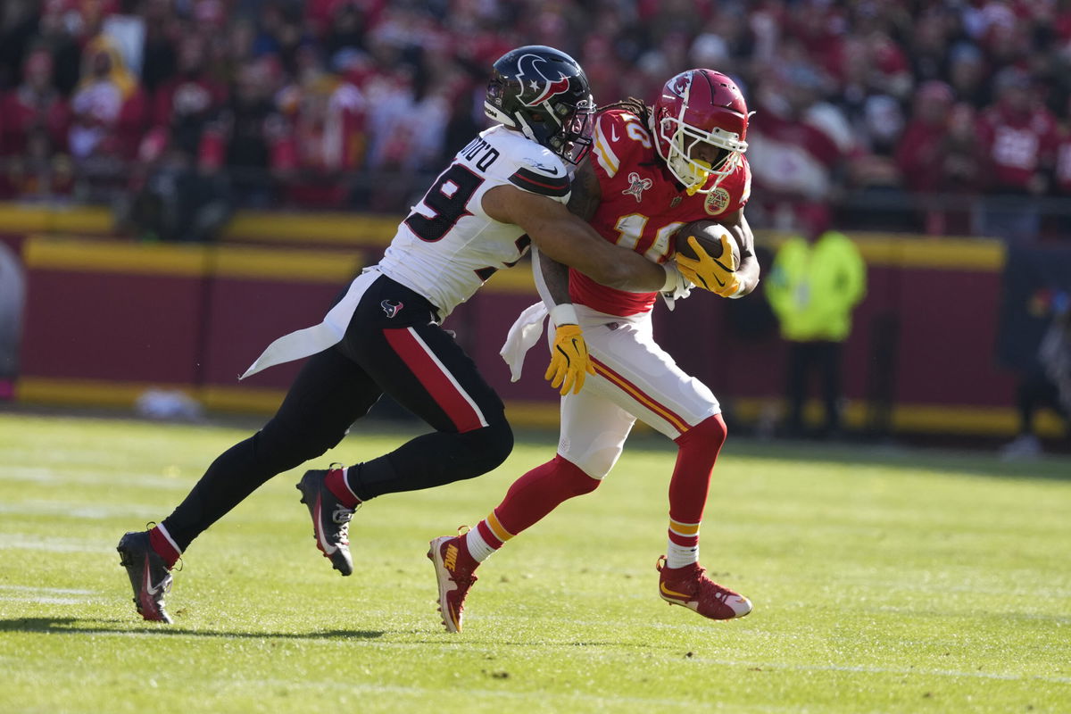 Kansas City Chiefs running back Isiah Pacheco, right, is stopped by Houston Texans linebacker Henry To'oTo'o during the first half of an NFL football game Saturday, Dec. 21, 2024, in Kansas City, Mo.