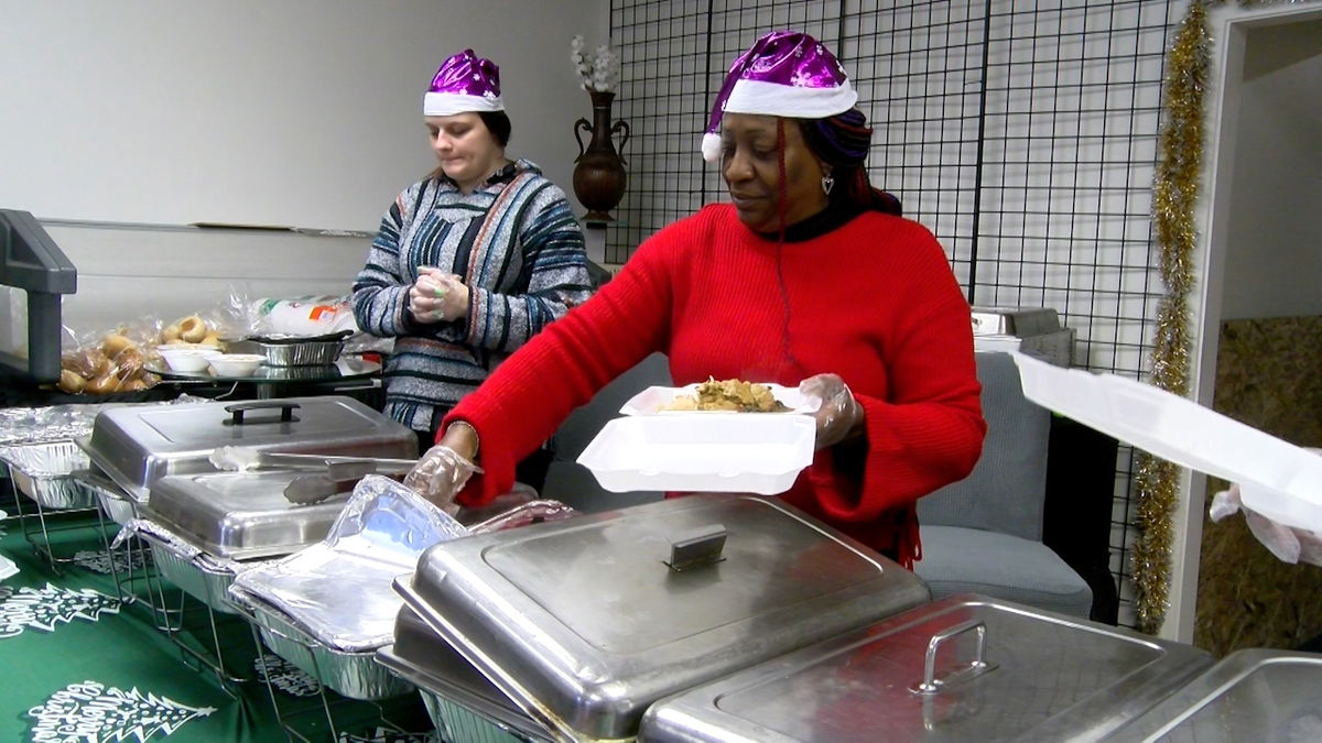 Sophia Smith, owner of nonprofit Sophia's Helping Hands, serves a plate of food at the group’s Christmas Day dinner event on Wednesday, Dec. 25, 2024.