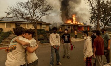 A person walks amid the destruction left behind by the Palisades Fire in the Pacific Palisades neighborhood of Los Angeles on January 9.