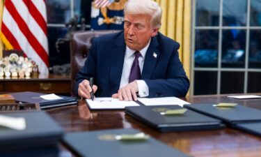 President Donald Trump signs executive orders in the Oval Office of the White House in Washington