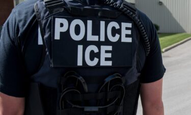 A US Immigration and Customs Enforcement special agents prepare to arrest alleged immigration violators at Fresh Mark in Salem