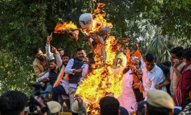 Demonstrators burn an effigy of US President Donald Trump