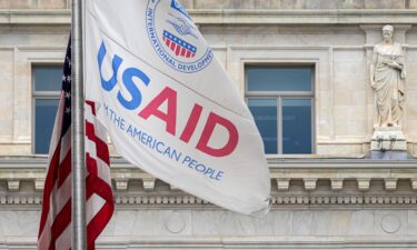 The US Agency of International Development (USAID) flag flies outside the agency's headquarters building on January 30