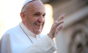 Pope Francis waves to the faithful upon his arrival for the weekly general audience at St. Peter's square in the Vatican on November 21