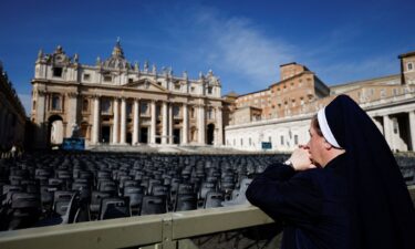 People have created a makeshift shrine for Pope Francis at a statue of John Paul II in front of the Gemelli Hospital in Rome.