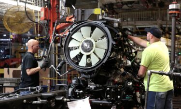 General Motors assembly workers attach the engine to the chassis of Chevrolet 2019 heavy-duty pickup trucks at General Motors Flint Assembly Plant in Flint