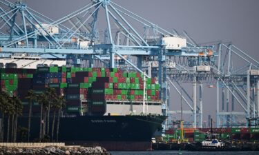 Cargo shipping containers sit on the Evergreen Ever Fame container ship docked at a container terminal at the Port of Los Angeles in Los Angeles