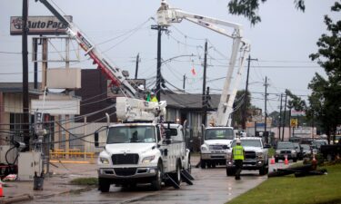 Utility crews work to restore electricity in Houston in the aftermath of Hurricane Beryl on July 11