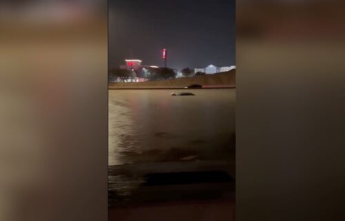 The roofs of some vehicles were seen peeking out of floodwaters on Interstate 35 just outside of San Antonio