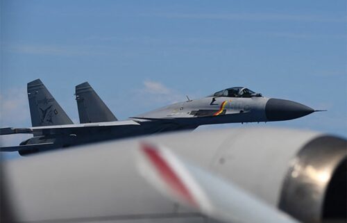This handout photo from Japan's Ministry of Defense shows a J-15 fighter jet making an unusual approach to a Japan Maritime Self-Defense Force P-3C patrol aircraft.