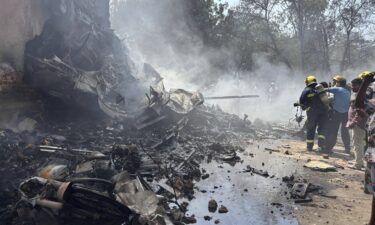 Firefighters work at the site of an airplane that crashed in India's northwestern city of Ahmedabad in Gujarat state