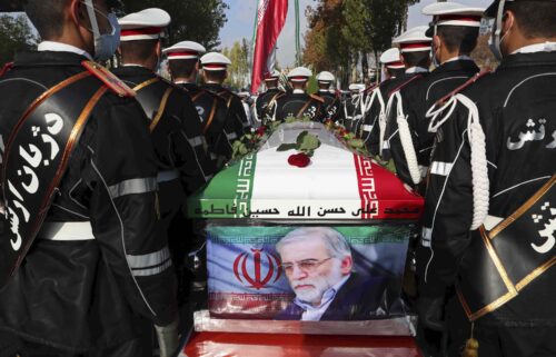 Military personnel stand near the flag-draped coffin of Mohsen Fakhrizadeh during his funeral in Tehran