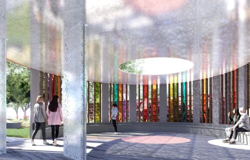 A visitor views photos at the Pulse Interim Memorial in Orlando. A permanent memorial is planned for the site where 49 people were killed at a popular gay nightclub in 2016.