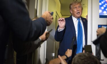 President Donald Trump speaks with reporters while flying aboard Air Force One en route from Calgary