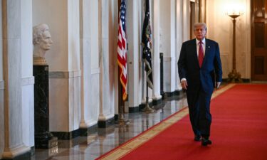 US President Donald Trump arrives to sign the GENIUS Act at the White House in Washington