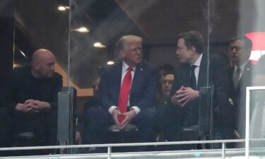President Donald Trump and Elon Musk talk at a memorial for Charlie Kirk Sunday.