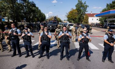 CPD officers stand in front of federal officers in the Brighton Park neighborhood of Chicago
